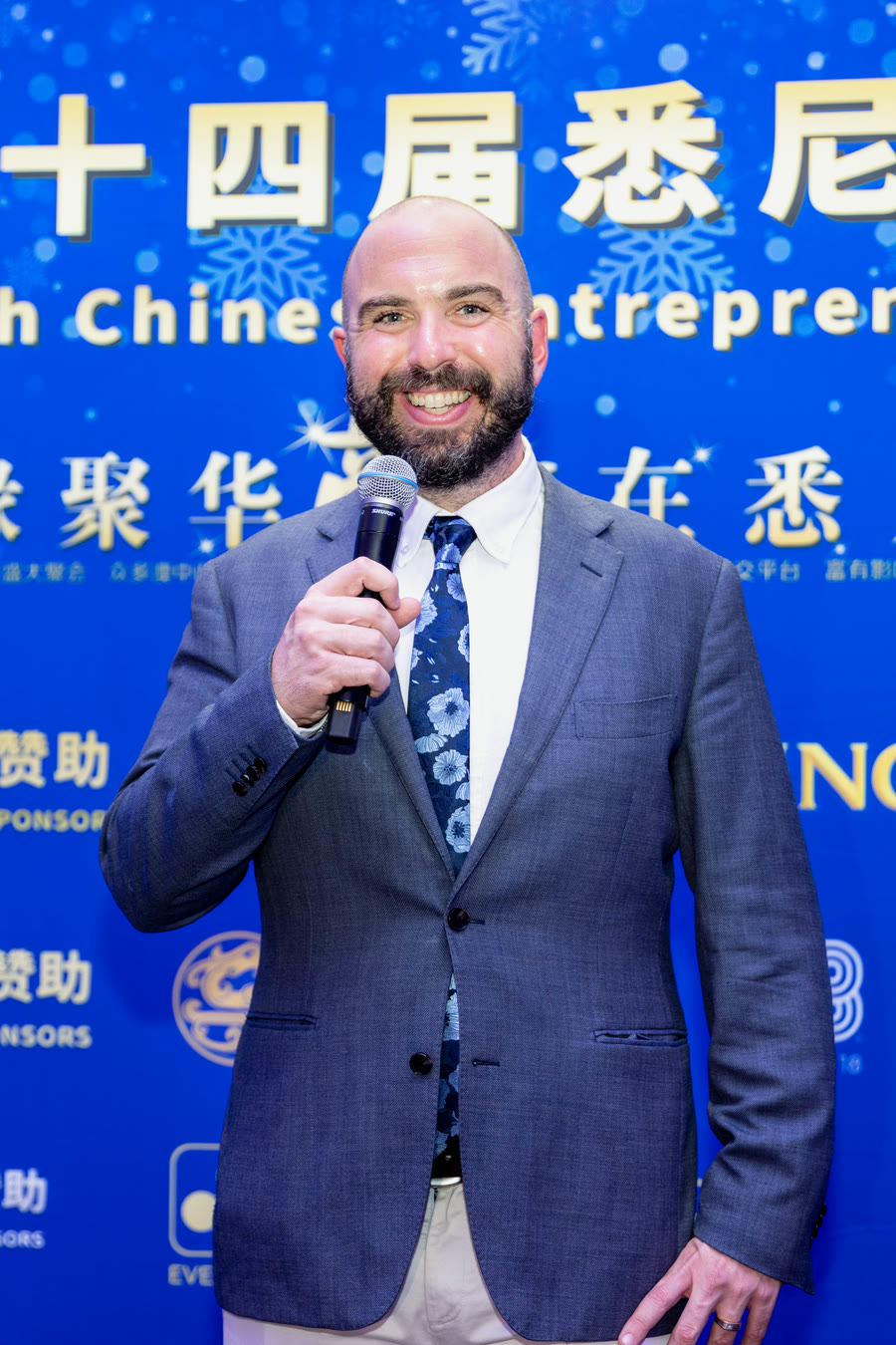 James Ashbridge with a microphone at the 2025 Sydney Chinese Entrepreneurs Gala